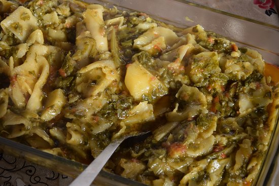 Close-up of Hoi Lo Garma showing spinach, potatoes, and sliced dough