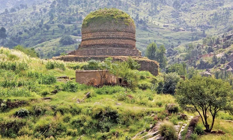 Photo of Butkara Stupa ruins at Mingora. Wide shot showing the stupa base and surrounding excavated structures.
