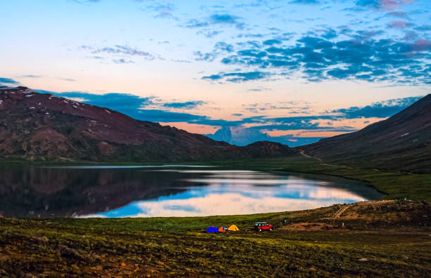 Wide photograph of Sheosar Lake, Deosai, showing the lake surface reflecting the sky and surrounding highland. 
